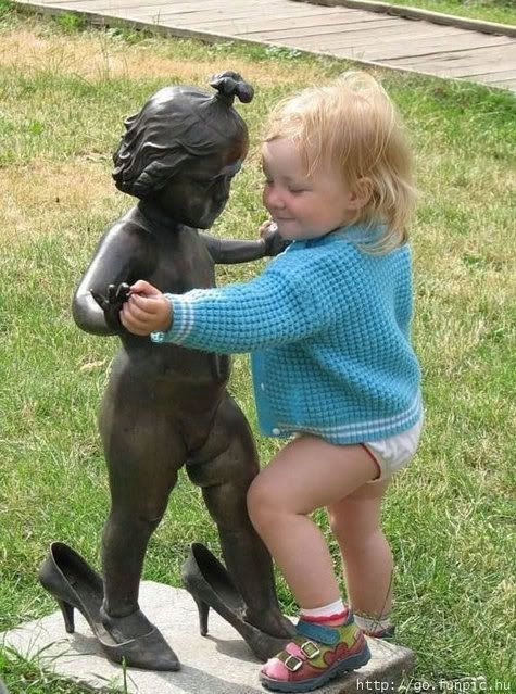 cute babies dancing with statue