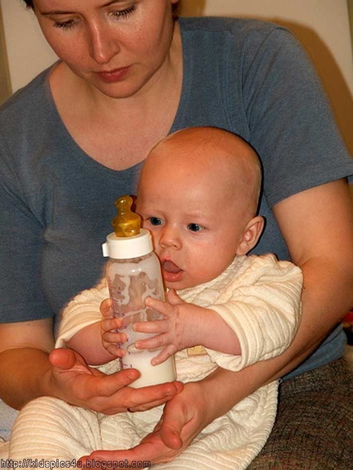 baby eating milk with mummy