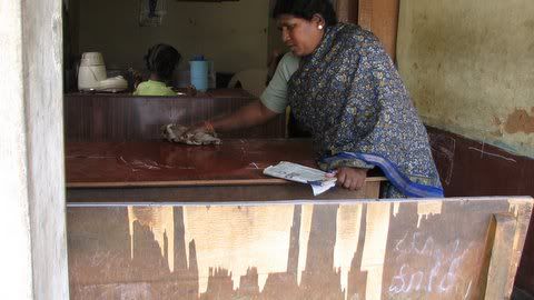 lady cleaning children's homework ragihalli village 171108