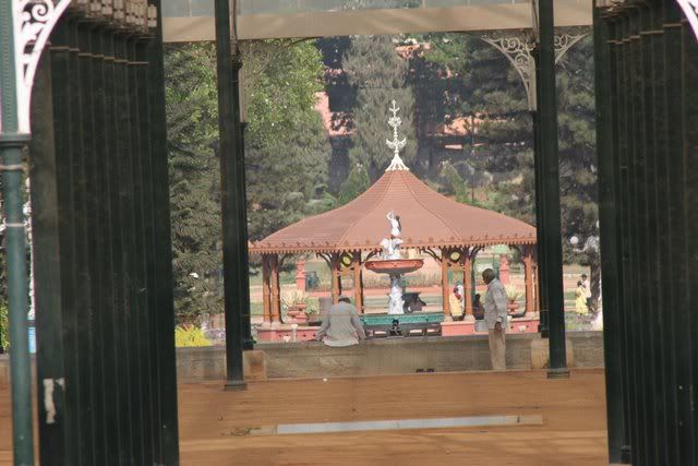fountain and bandstand through glass house lalbagh