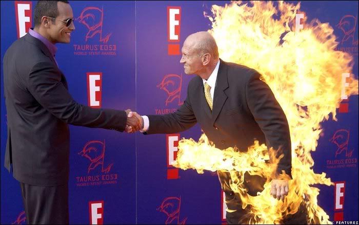 Jim Trella (right) wears a flaming suit to greet host The Rock at the 2005 World Stunt Awards